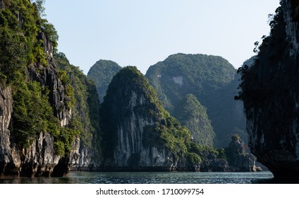 Ha Long Bay In Vietnam, Multiple Small Islands With Cruise Boats And Fishing Boats And Fishing Villages