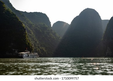 Ha Long Bay In Vietnam, Multiple Small Islands With Cruise Boats And Fishing Boats And Fishing Villages