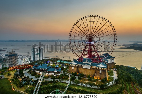 HA LONG, VIETNAM - SEP\
28, 2018: Top view aerial photo from flying drone of a Ha Long City\
with development ferris wheel, aerial cable or telepheric. Near Ha\
Long bay