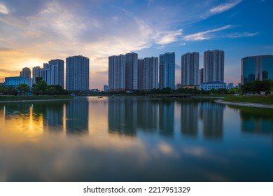 Ha Noi, Vietnam, October 07 2022: Illuminated Modern Apartments, As Known As A Part Of Urban Life, Are Reflected At Sunset Moment.