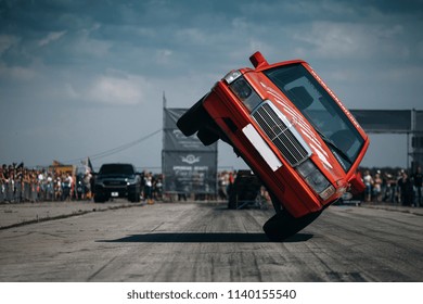 Haapsalu, Estonia - JUL 15, 2018: American Car Beauty Show Driver Of Mercedes Benz Make Stunt Trick At The Show. Driving Car On Two Wheels 