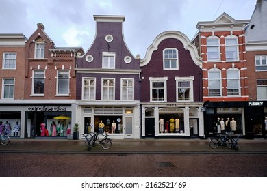 Haarlem, Holland, May 24, 2022: Empty shopping street Zijlstraat in Haarlem in the early morning.  Fashion stores with traditional Dutch gable facades.