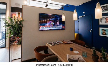 Haarlem, Netherlands - Aug 17, 2018: Upscale Hotel Lobby With Digital Flat Screen Tv Showing CNN News Channel With Braking News Music Legend Aretha Franklin Dies At Age 76 - Singing At Obama