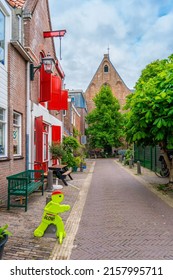 Haarlem, The Netherlands - March 2022: Cozy green little street in Haarlem. Concept social inclusion and climate change. Street view generic architecture Haarlem typical Dutch style buildings.