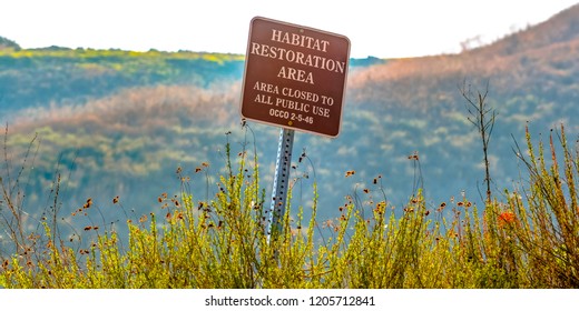 Habitat Restoration Area Sign On A Grassy Mountain