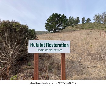 Habitat Restoration sign posted outdoor on wooden posts