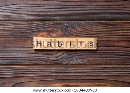 HABITS word written on wood block.