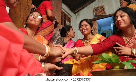 Habra, India- 30th May, 2016: Picture of wedding ritual. There are many people around the Bride. Those women are enjoying the wedding ceremony. Her expression is beautiful. Selective focus concept. - Shutterstock ID 1892376337