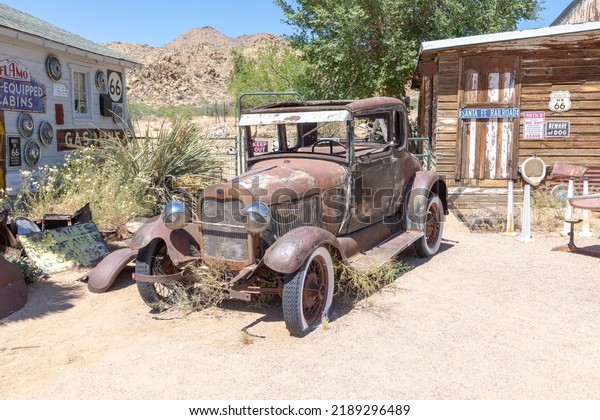 Hackberry, USA - May\
25, 2022: Hackberry General Store with an old rusty vintage car in\
Hackberry , Arizona, USA. Hackberry General Store is a popular\
museum of old Route\
66.