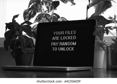 Hacked by Ransomware with Your Files Are Locked Pay Ransom to Unlock Files Message, Concept Photo of Ransomware showing how Anyone Could Be Hacked and is potentially Vulnerable. - Shutterstock ID 641356039