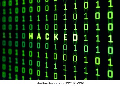 Hacked Word On Binary Code Background Of A Computer Screen