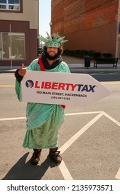 HACKENSACK, NJ, USA  - March 11, 2022: Man Promoting Liberty Tax At 193 Main St, Hackensack, NJ 07601. Editorial Use Only. 