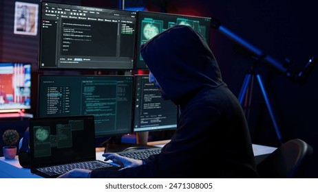 Hacker arriving in hidden underground shelter, prepared to launch DDoS attack on websites. Cybercriminal in apartment starting work on script that can crash businesses servers, camera B