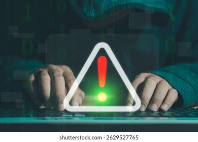 A hacker attacks and hacks data on computers. A businessman is using a computer with a triangle caution warning sign for notification error and maintenance concept. cybercrime, security, ransomware.