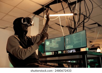 Hacker breaking into databse in vr glasses, spyware coding experience, african american man cracking computer system password in metaverse. Cybercrime, internet criminal developing malware