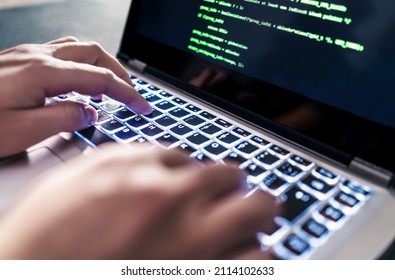 Hacker code in laptop. Cyber security, privacy or hack threat. Coder or programmer writing virus software, malware, internet attack or developing digital design. Green web data in computer screen. - Shutterstock ID 2114102633