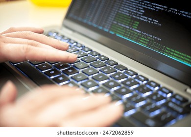 Hacker code on a laptop, highlighting issues of cybersecurity, privacy threats, data leaks and server processes. A cybersecurity expert identifies vulnerabilities and scrutinize virus code and malware - Powered by Shutterstock