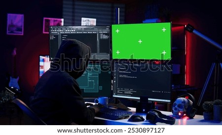 Hacker coding on isolated screen computer monitors, developing zero day exploit undetectable by antivirus. Evil IT engineer using chroma key PC displays to build script tricking firewalls, camera B