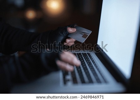 Hacker, credit card and finance on laptop at night by hacking software database, password or security attack for financial information. Criminal, typing and digital banking fraud for privacy risk