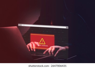 hacker in a dark room with a laptop red System Warning on the screen. Concept of cyber threats and cybersecurity breach alert with binary code online internet technology.