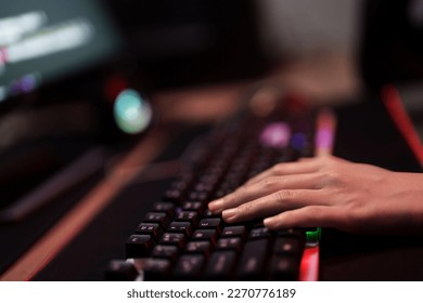 Hacker in dark room using keyboard stealing data on internet. - Shutterstock ID 2270776189