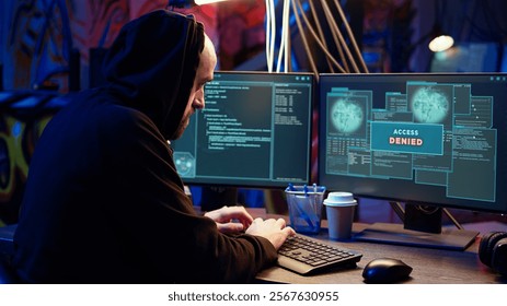 Hacker in dark underground warehouse trying to steal valuable data by targeting governmental websites but getting access denied error message, having cyber attacks rejected, dolly in close up shot - Powered by Shutterstock - Get 15% off with code: PIKWIZARD15