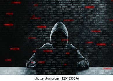 Hacker at desk using laptop with binary code. Computing and phishing concept. Double exposure 