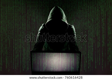 Hacker in front of his computer. Dark face