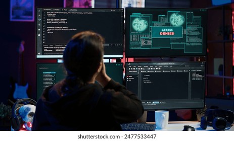 Hacker getting access denied error while doing computer sabotage using ransomware. Cybercriminal failing to penetrate firewalls while trying to steal victim data, camera A