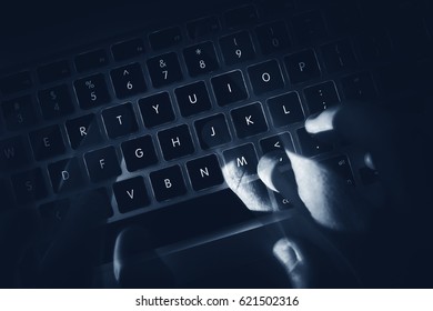 Hacker Hands In Motion On The Laptop Keyboard. Dark Computer And Network Safety Concept Photo.