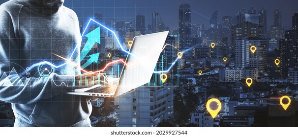Hacker hands using notebook with glowing business chart on dark city background with location marks. GPS, logistics and finance concept. Double exposure
