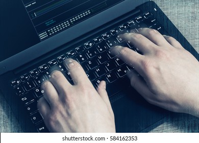 Hacker Hands At Work On A Laptop. First Person View.