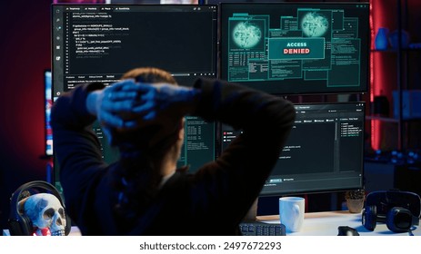 Hacker in hidden apartment trying to steal valuable data by targeting governmental websites but getting access denied error message, having cyber attacks rejected, camera A