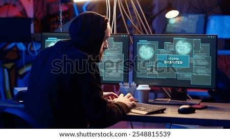 Hacker in hidden base successfully getting past anti tamper measures implemented by companies to protect products. Cracker pirating software and video game releases, camera B