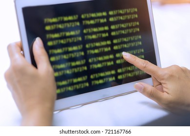 Hacker holding and touchscreen tablet