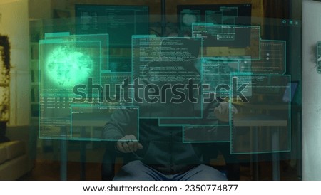 Hacker at home using augmented reality holographic visualization to write malicious code to be used as virus, planning to infect businesses internal servers, steal valuable data and demand ransom