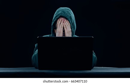 Hacker in the hood, a hacker on a dark background                               