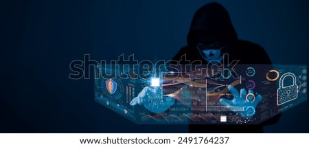 A hacker in a hoodie is hacking into a computer screen. Concept of danger and suspense, as the man is attempting to gain unauthorized access to the system