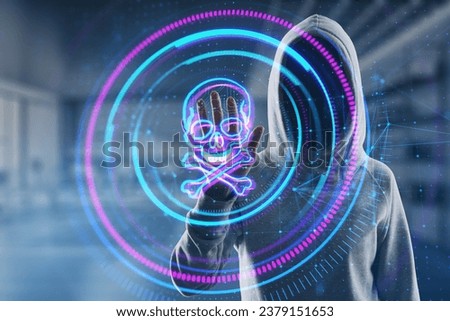 Hacker in hoodie using creative digital round skull hologram on blurry office interior background. Hacking, piracy and malware concept. Double exposure