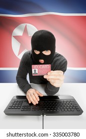 Hacker With ID Card In Hand And Flag On Background - North Korea