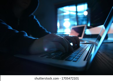 Hacker With Laptop In Dark Room, Closeup. Cyber Crime