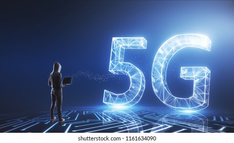 Hacker with laptop standing on glowing 5G background. Mobile internet and thief concept.
