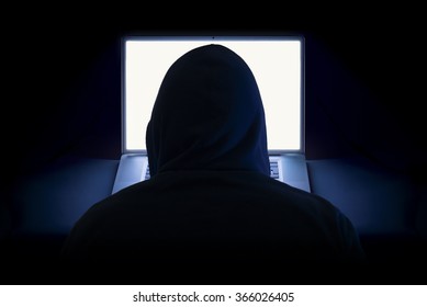 Hacker With Laptop Wearing Hoodie