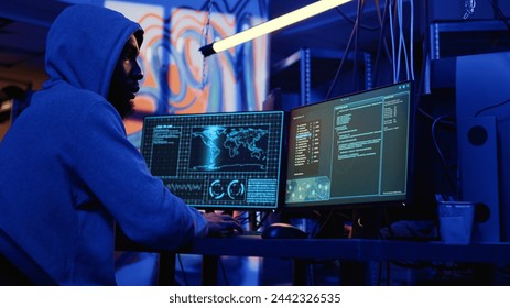 Hacker with malicious intent doing data breaches and financial theft in dark bunker. Cybercriminal stealing users bank account credentials, targeting low security passwords