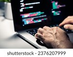 Hacker with malware code in computer screen. Cybersecurity, privacy or cyber attack. Programmer or fraud criminal writing virus software. Online firewall and privacy crime. Web data engineer.