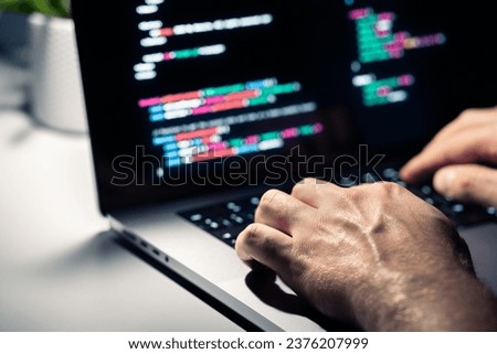 Hacker with malware code in computer screen. Cybersecurity, privacy or cyber attack. Programmer or fraud criminal writing virus software. Online firewall and privacy crime. Web data engineer.