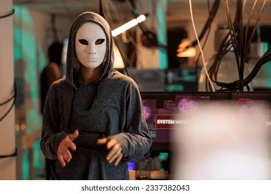 Hacker in mask hacking computer system password, breaking into online server, anonymous attacking database. Cybercrime, woman hacker stealing information portrait at night time