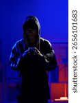 Hacker operating smartphone to execute phishing scheme and steal sensitive information through cyber intrusion