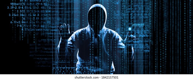 Hacker prints a code on a laptop keyboard to break into a cyberspace - Shutterstock ID 1842157501