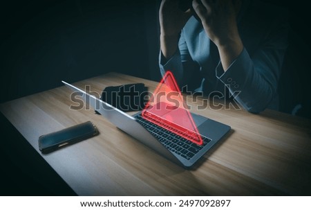 Hacker or programmer using laptop with triangle caution warning sign, coding, cryptography, hacker, crime, virus, for notification error and maintenance concept. Computer with red warning sign.